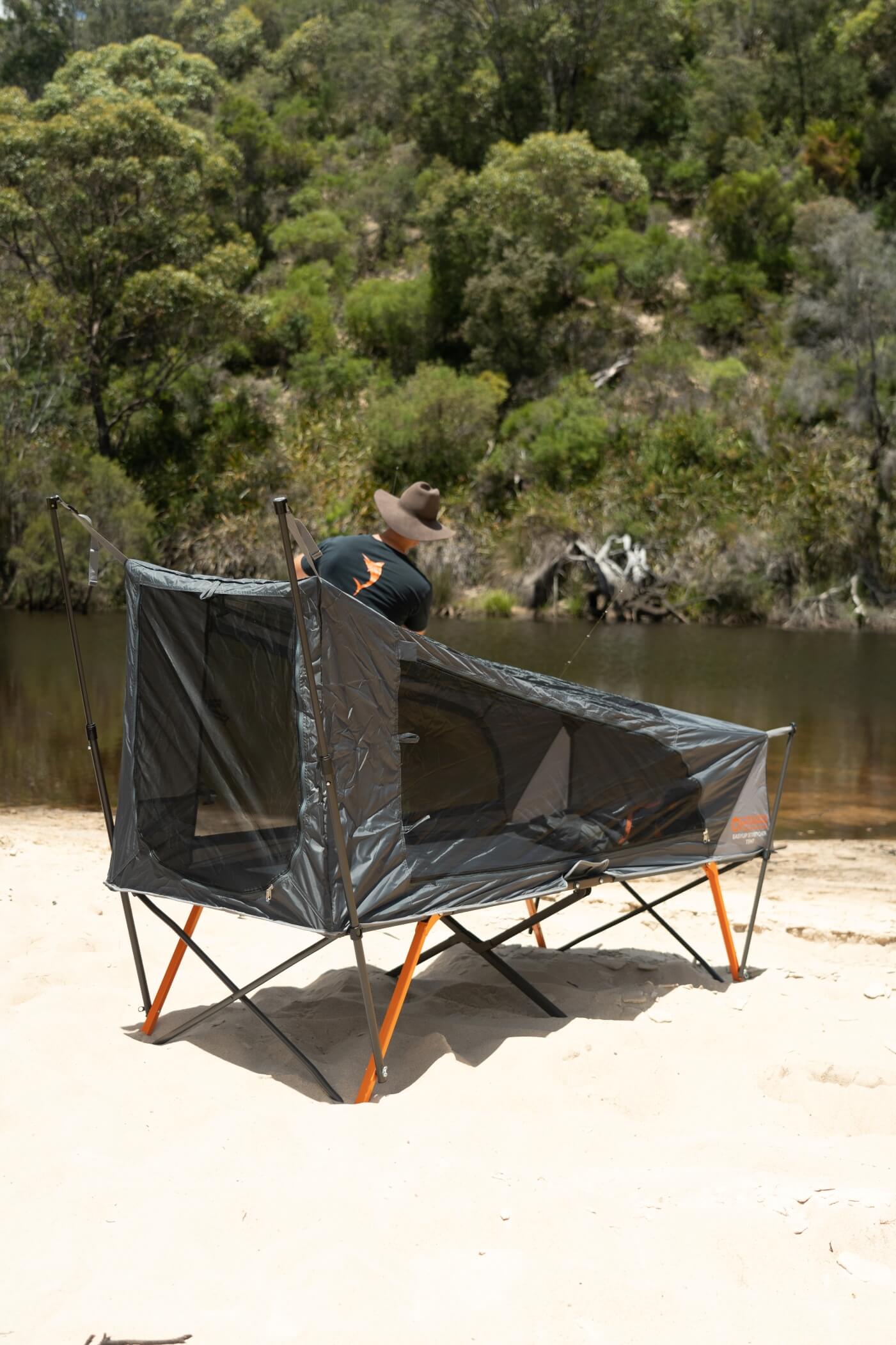 Compact Wildtrak Leisure Australia Stretcher Tent placed in a shaded forest campsite.