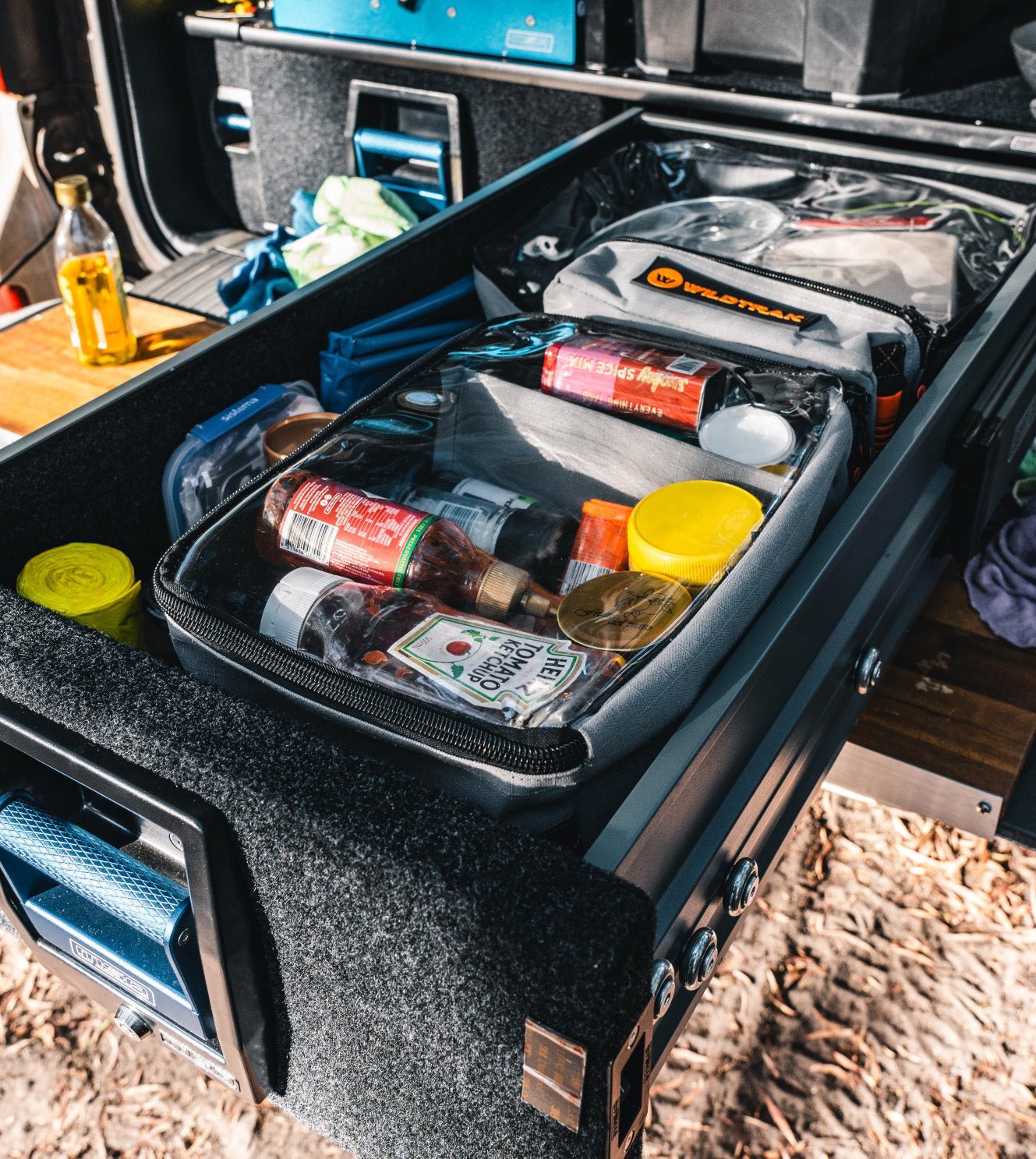 Wildtrak canvas bags for camping neatly arranged inside a 4WD setup.